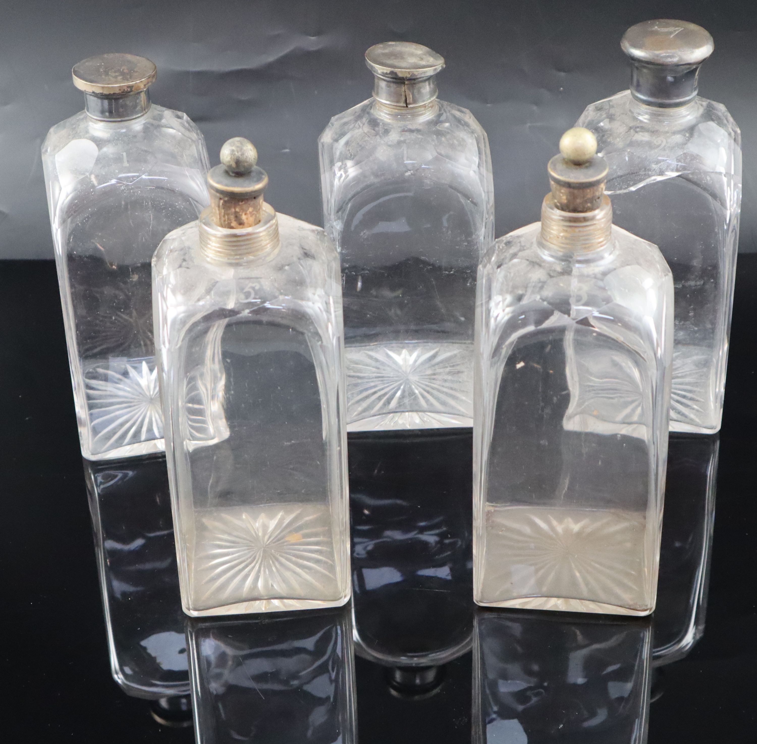A part set of five early 19th century cut glass decanters, 23cm